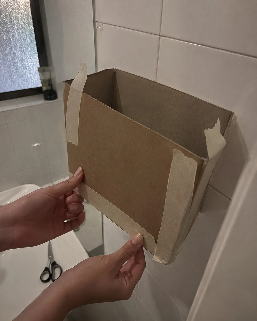 The first Snaggle prototype: a cardboard box taped to shower tile