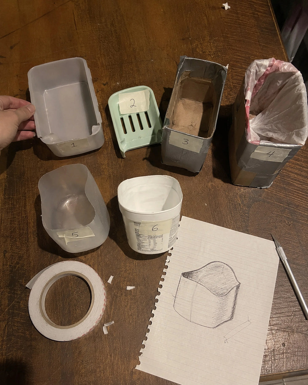 Early Snaggle prototypes: a lunchbox, a soap dish and sketches on the kitchen table